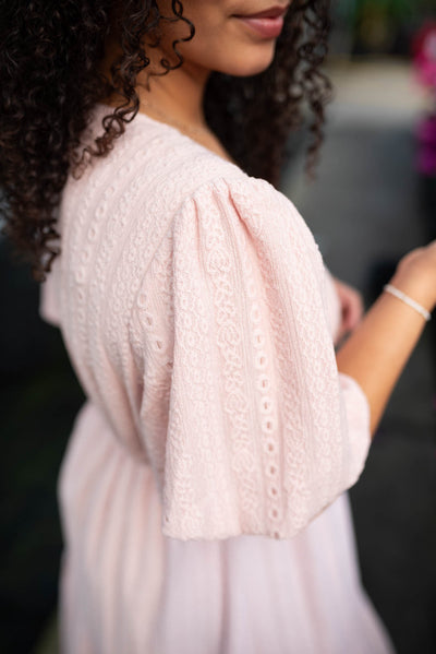 Close up of the fabric on the blush lace dress