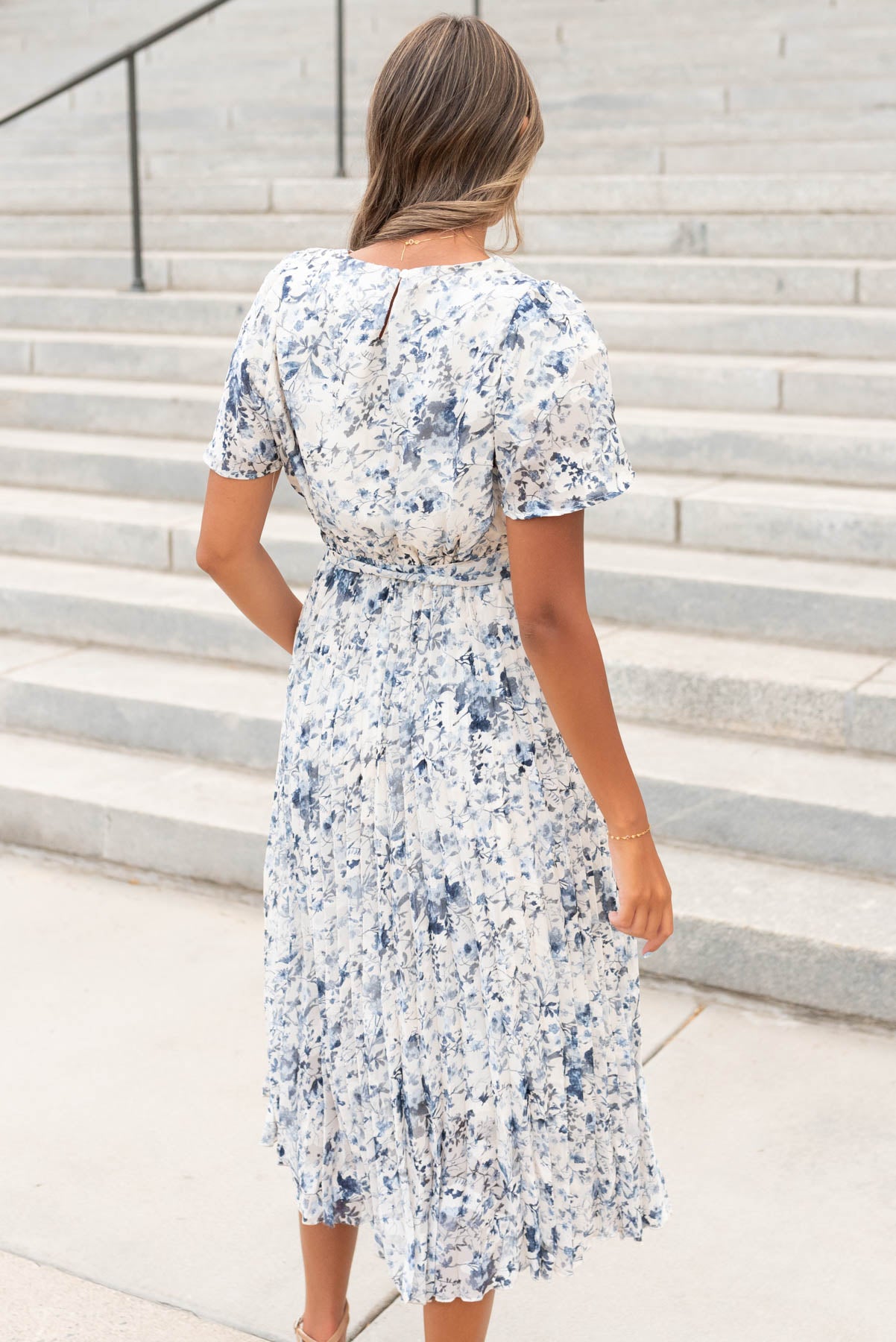 Back view of the blue floral pleated dress