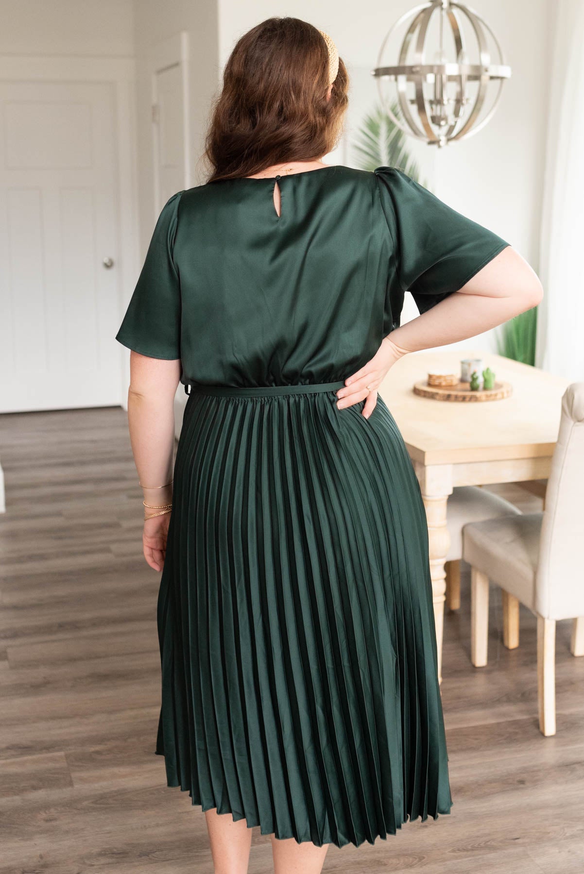 Back view of the plus size hunter green satin pleat dress