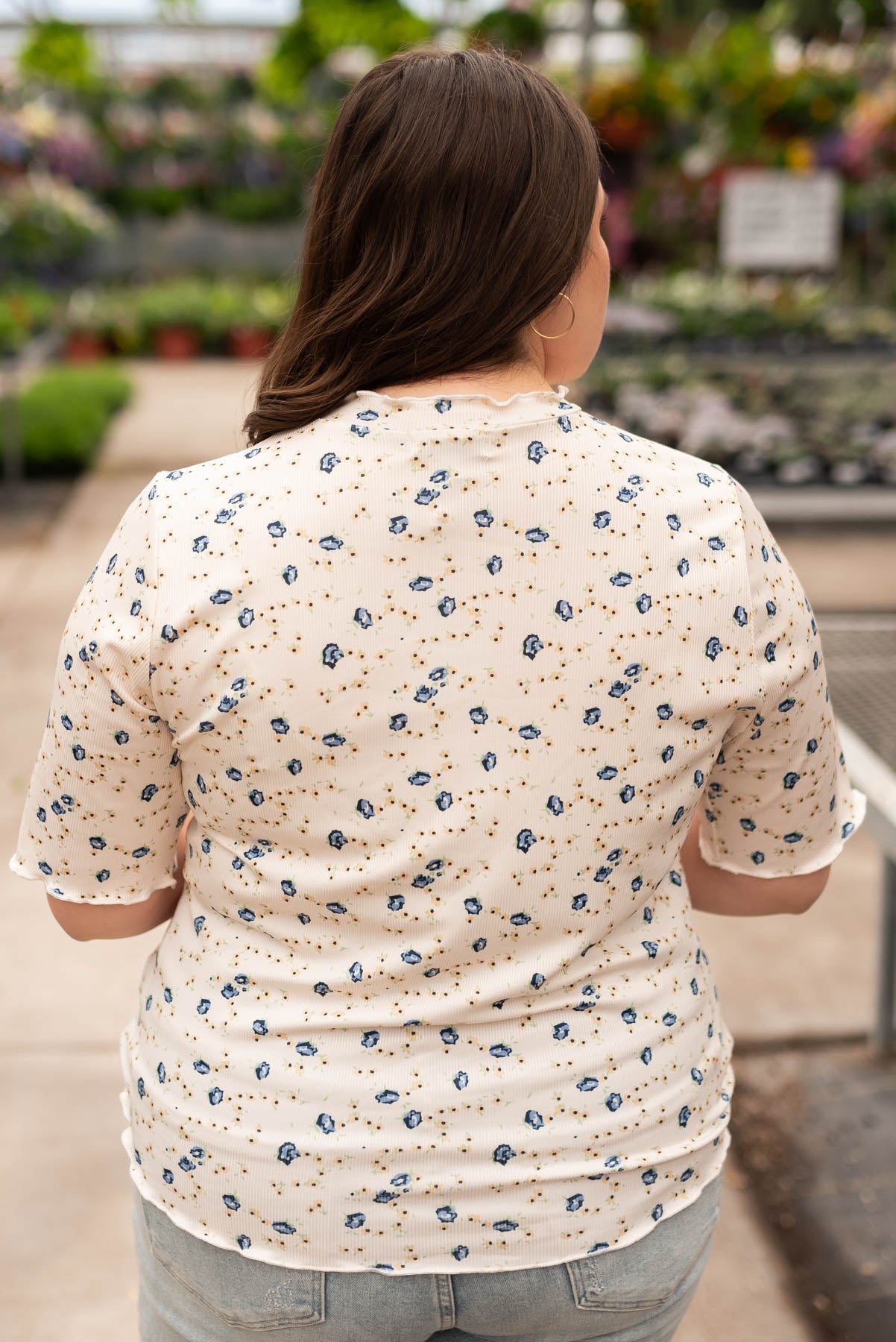 Back view of the plus size cream floral top