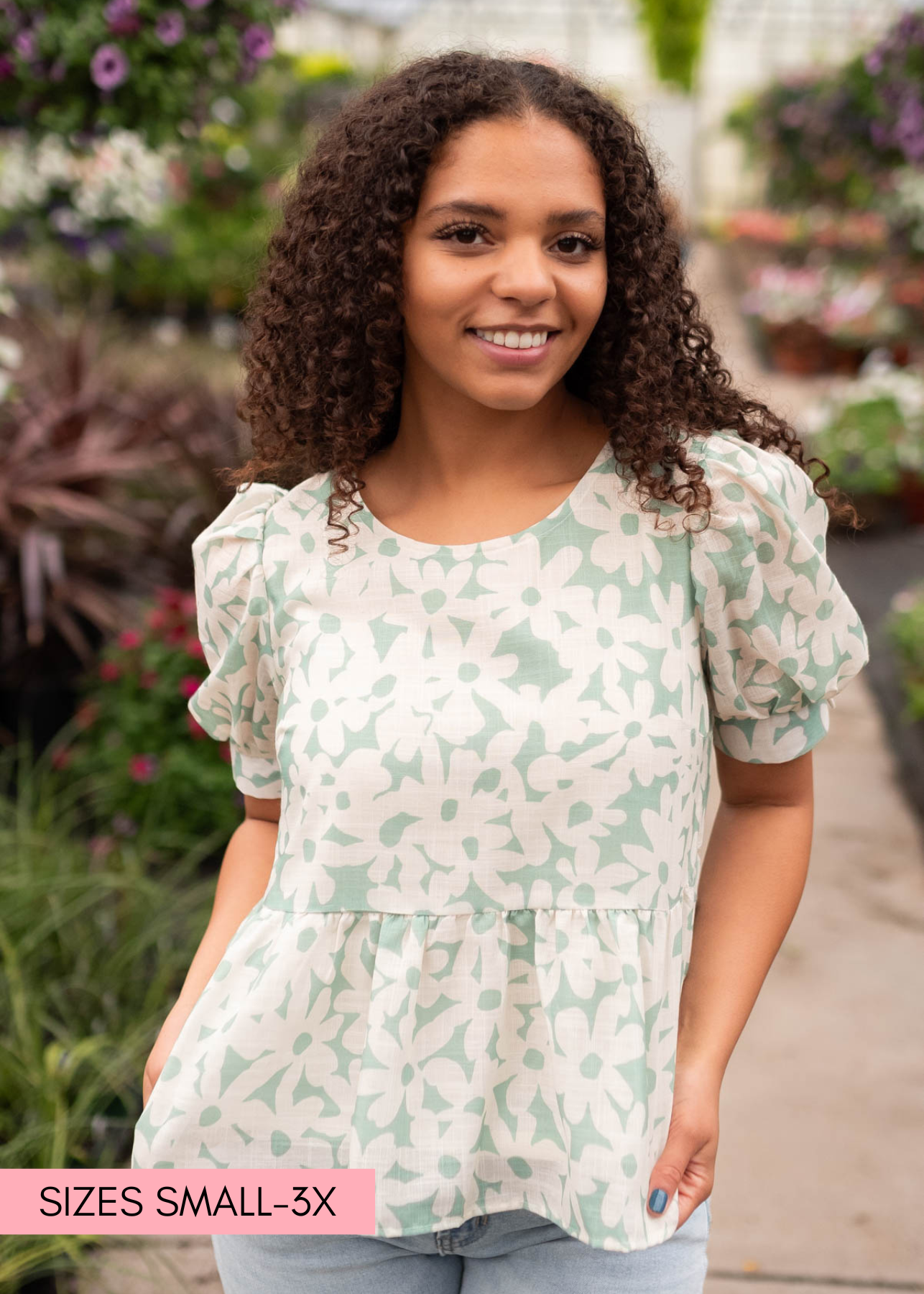 Medium green floral blouse with a peplum waist