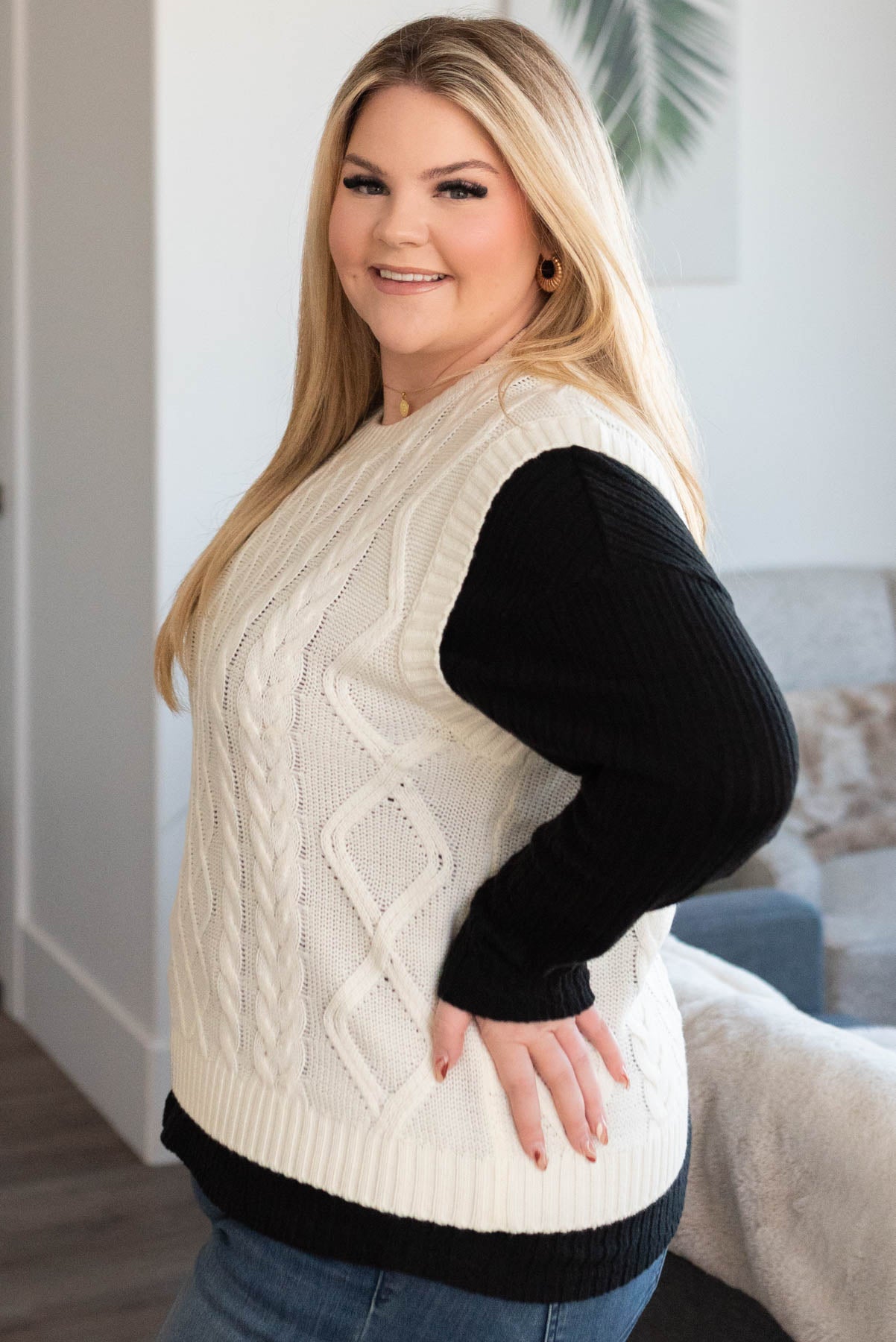 Side view of a ivory sweater vest