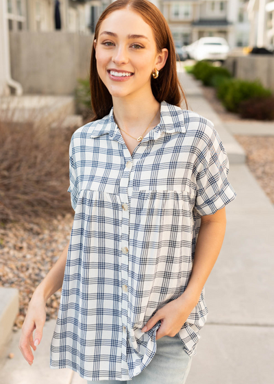 Navy button down top with collar and cuffs on the sleeves