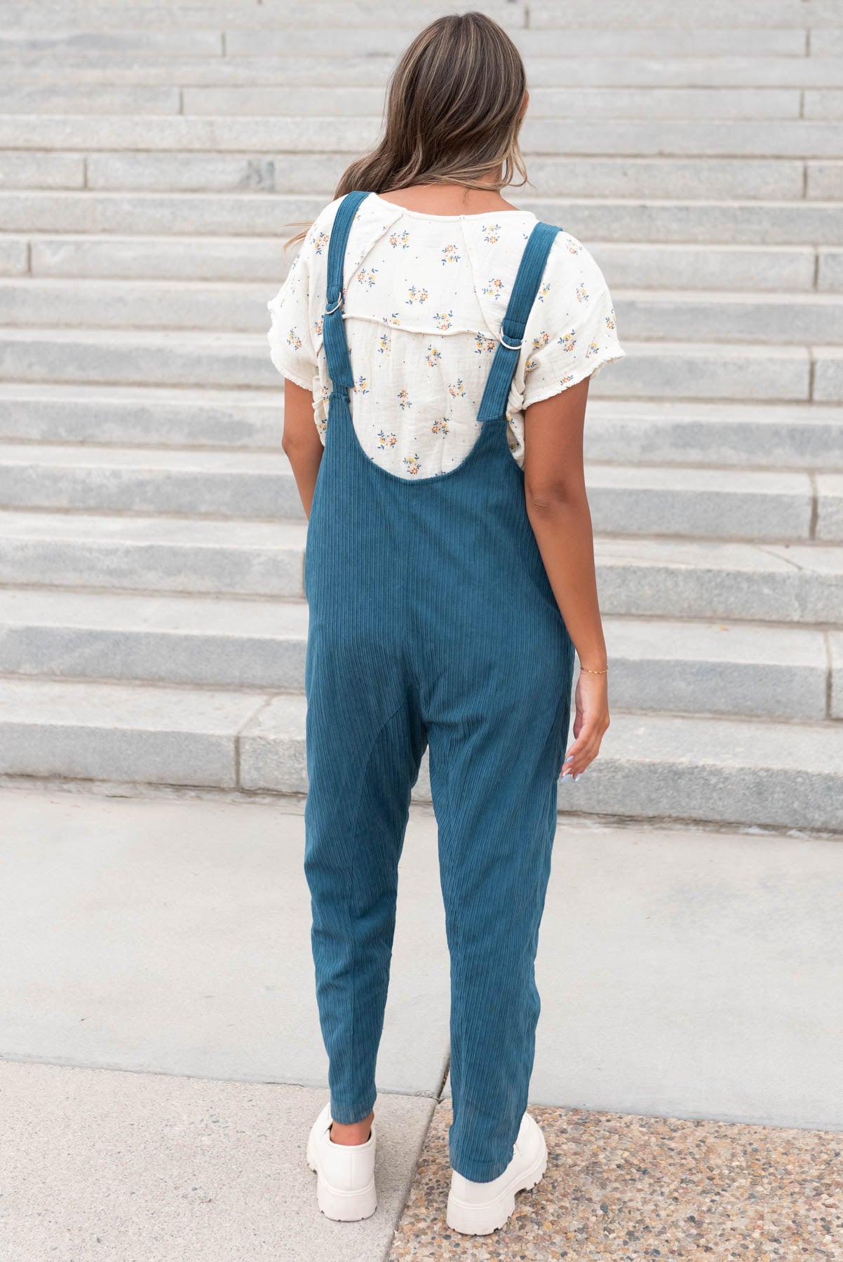 Back view of the deep aqua corduroy overalls