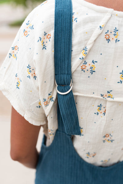 Close up of the adjustable back straps on the deep aqua corduroy overalls