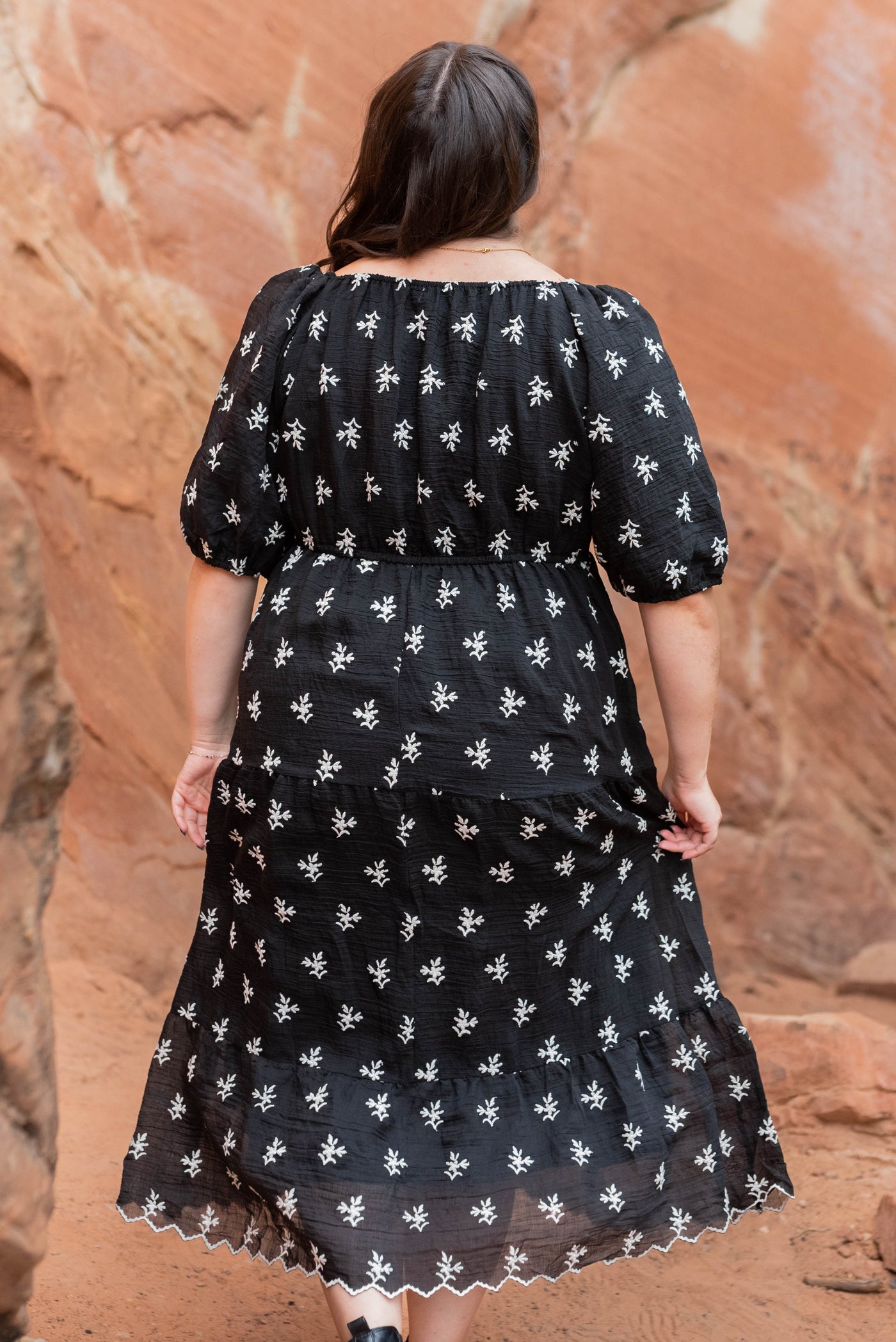 Back view of the plus size black floral tiered dress