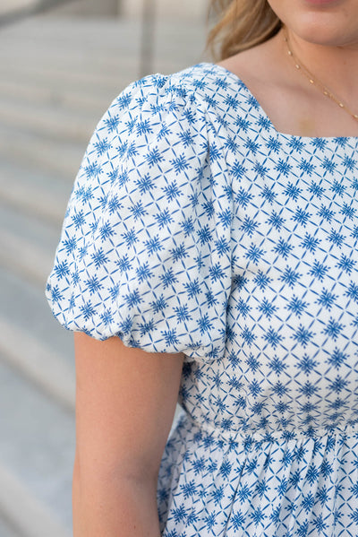 Close up of the sleeve and the fabric on the blue patterned dress