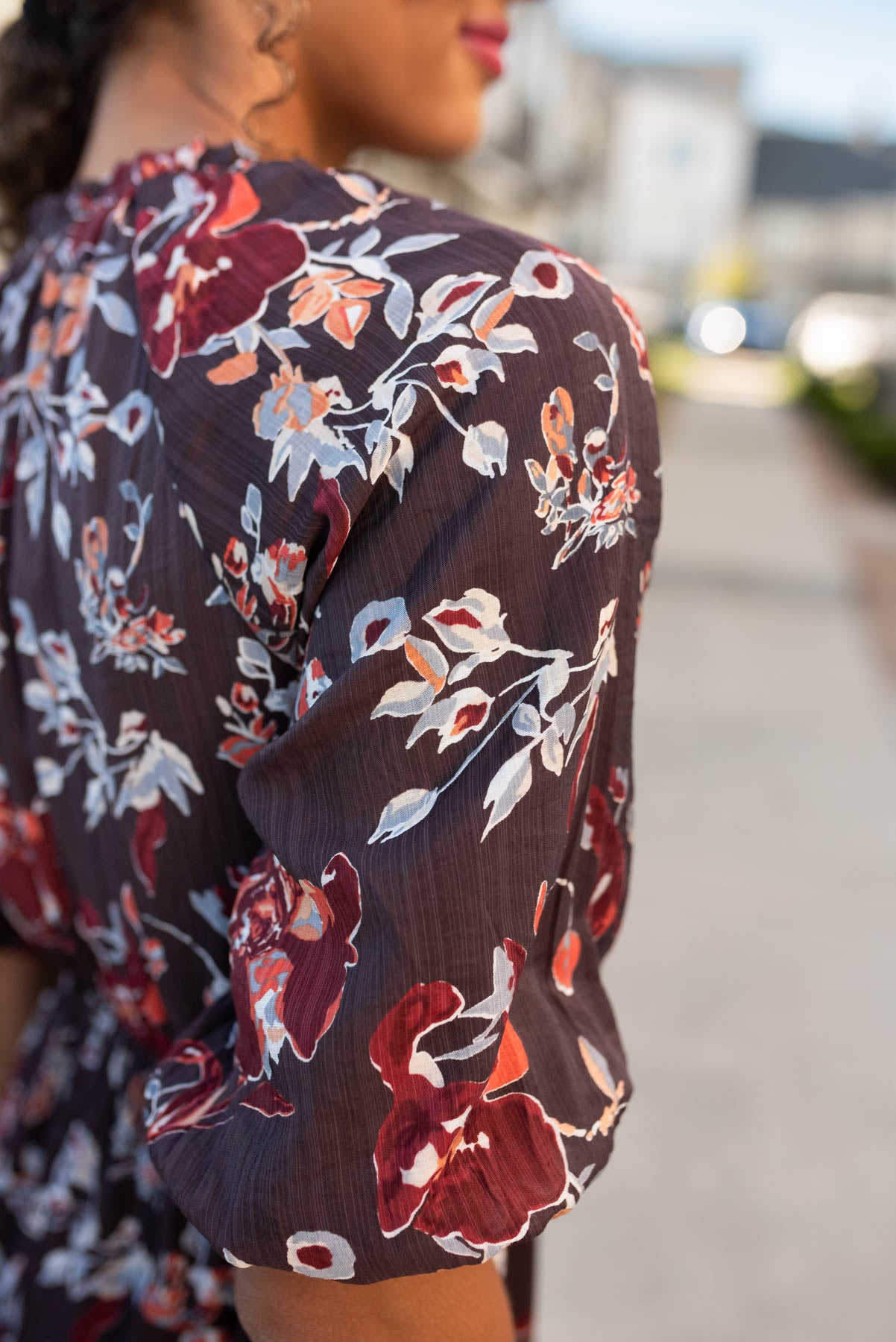 Close of the print on the dark plum floral dress