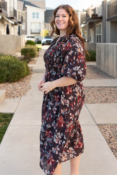 Side view of the plus size dark plum floral dress