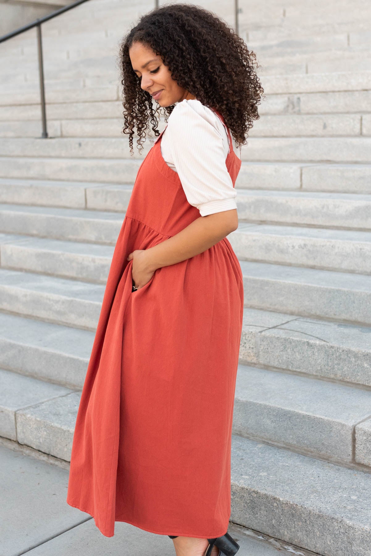 Side view of the burnt orange overall dress