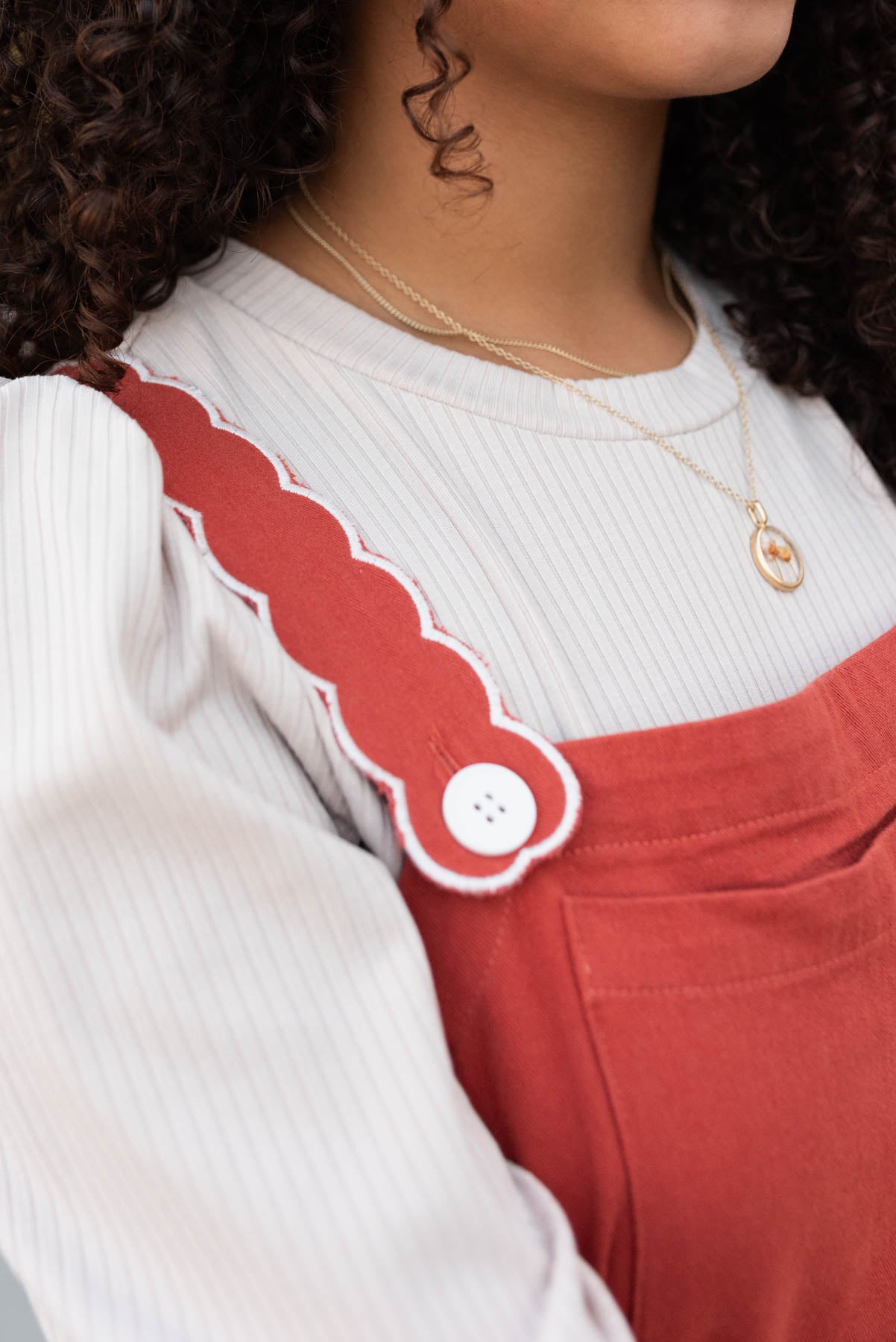 Close up of the strap on burnt orange overall dress