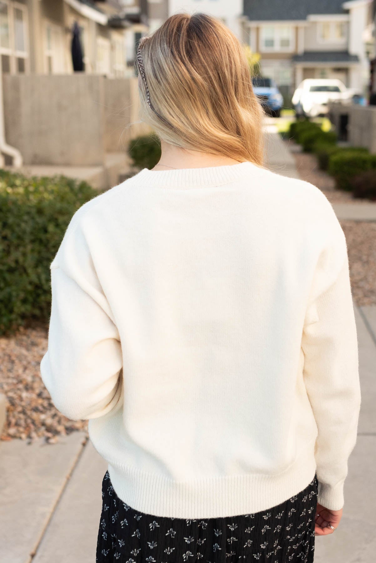 Back view of the cream floral sweater