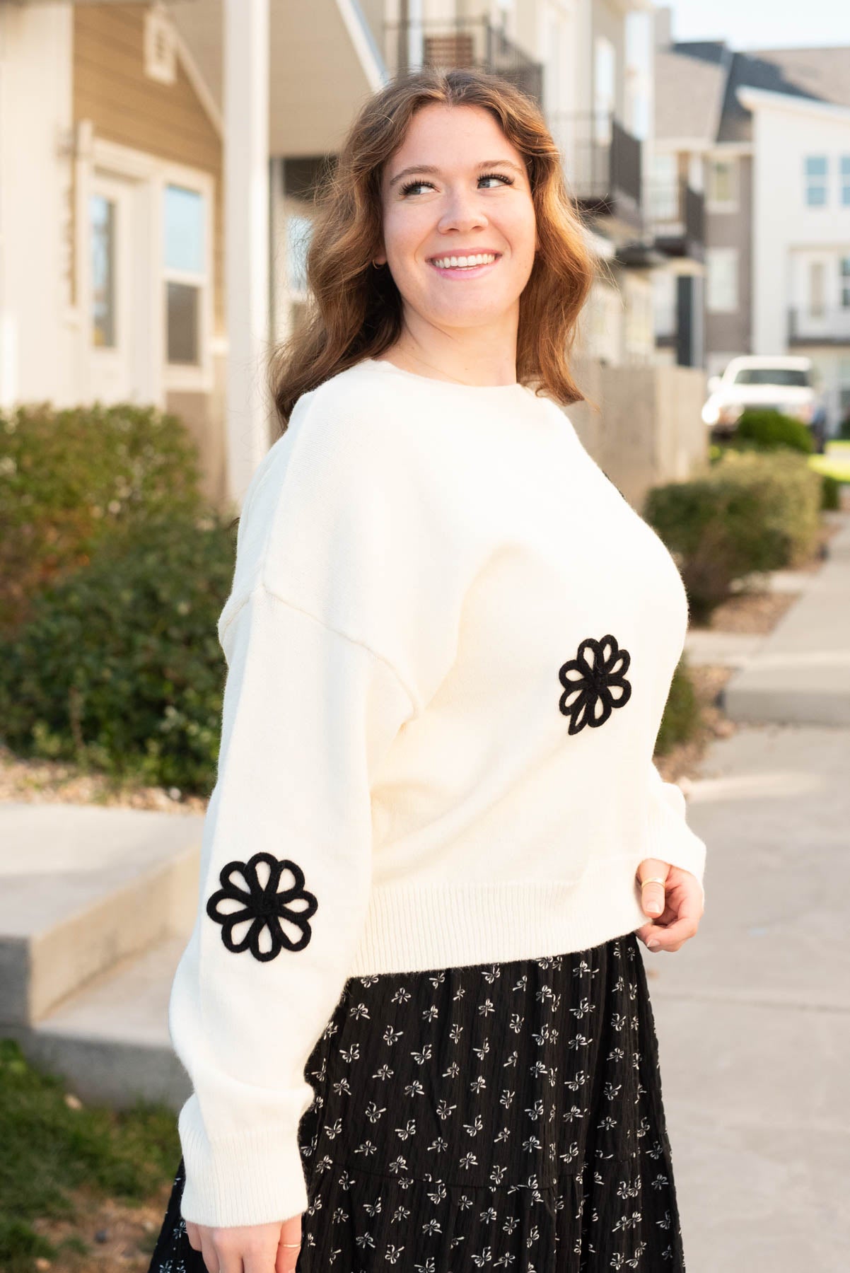 Side view of the plus size cream floral sweater