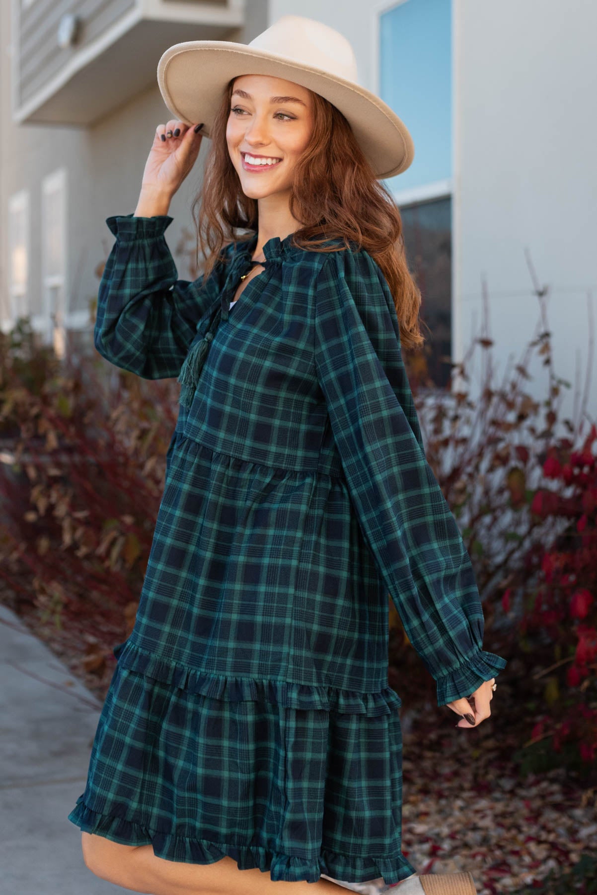 Side view of a plaid hunter green tiered dress