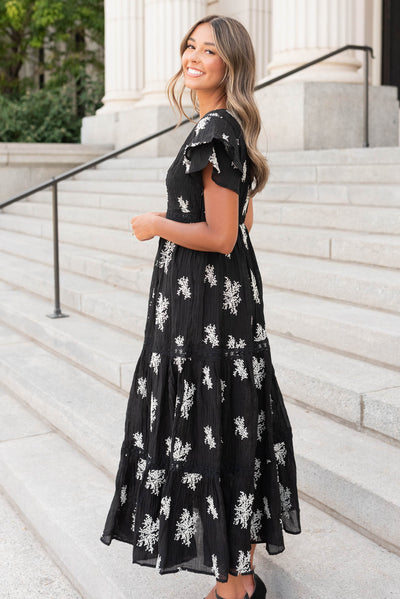 Side view of the black embroidered tiered dress