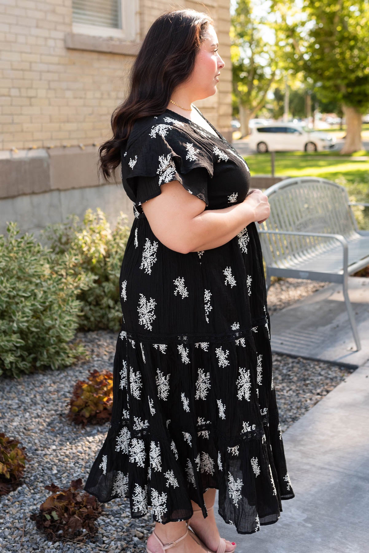 Side view of the black embroidered tiered dress