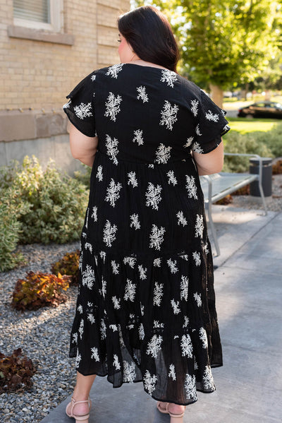 Back view of the plus size black embroidered tiered dress