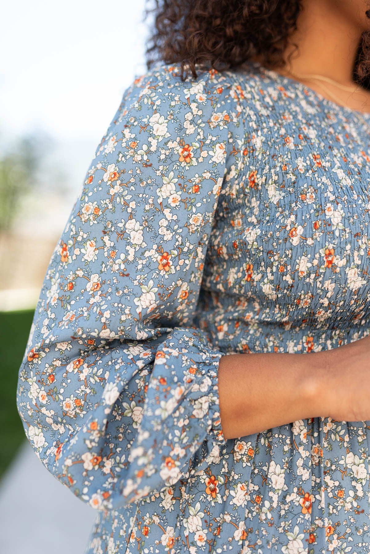 Close up of the sleeve and fabirc on the blue floral smocked dress