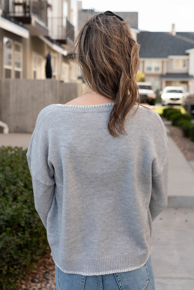 Back view of the heather grey bow sweater