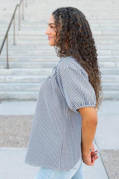 Side view of the black plaid collared top