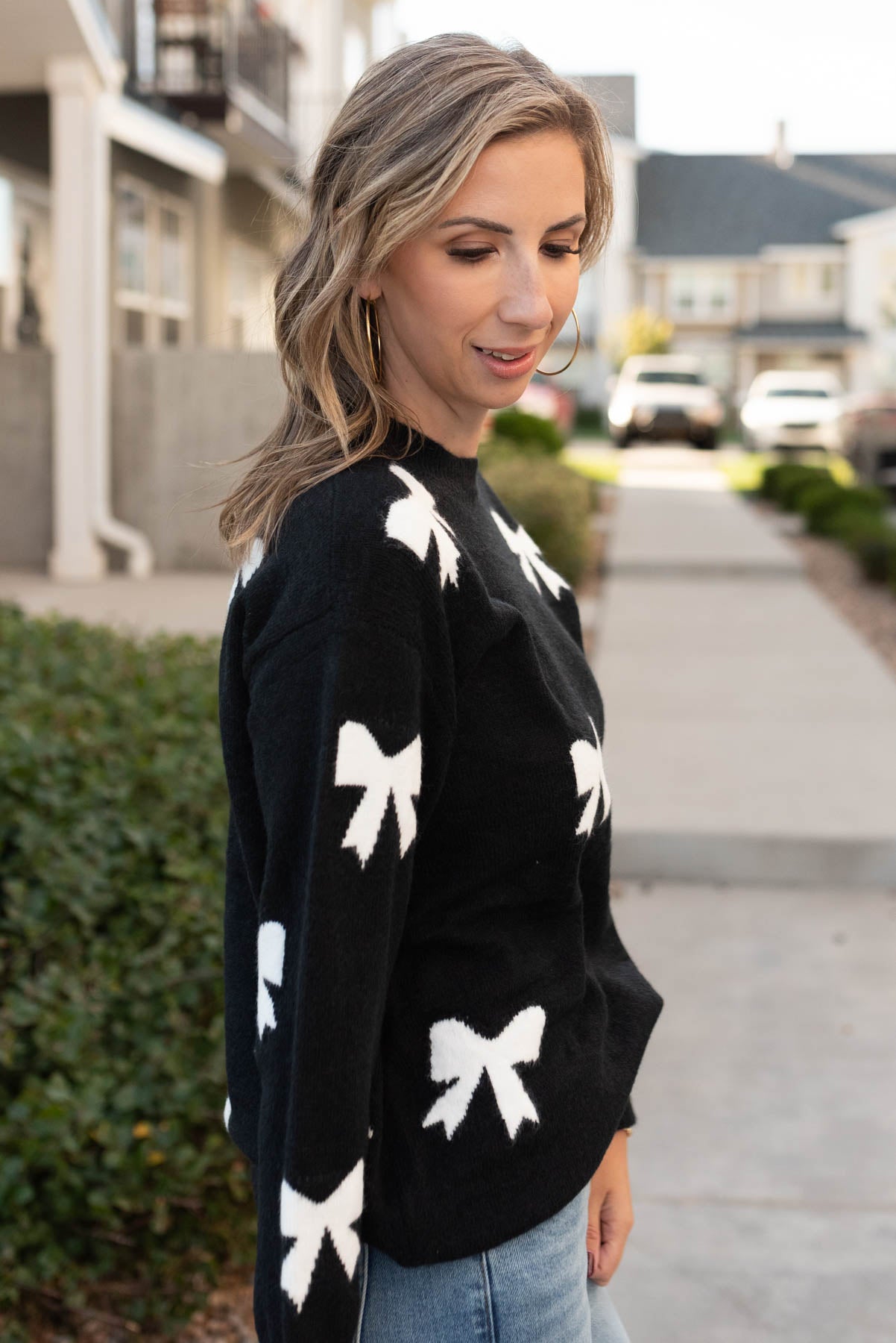 Side view of the black bow sweater