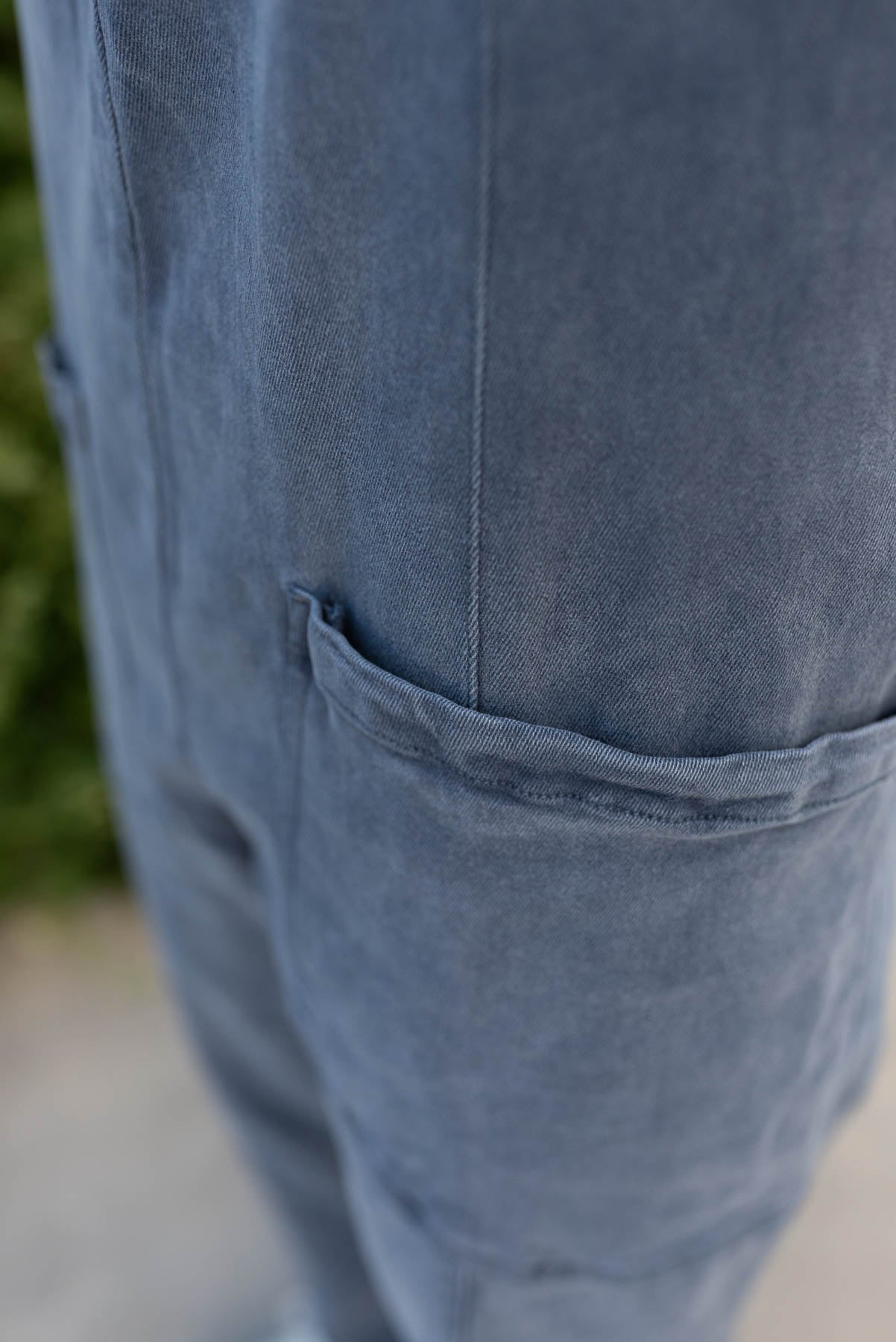 Close up of the pockets on the blueberry denim overalls