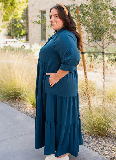 Side view of the deep teal tiered dress in plus size