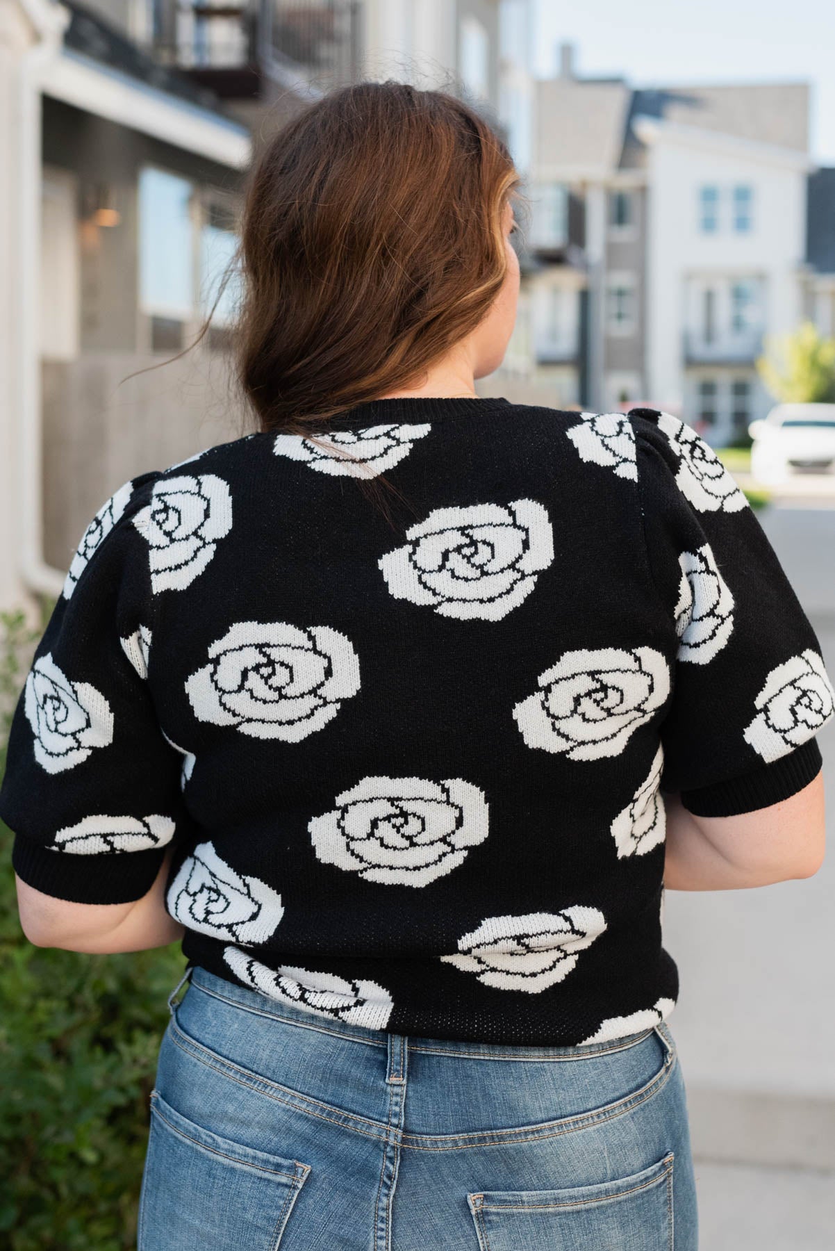 Back view of the plus size black floral print sweater