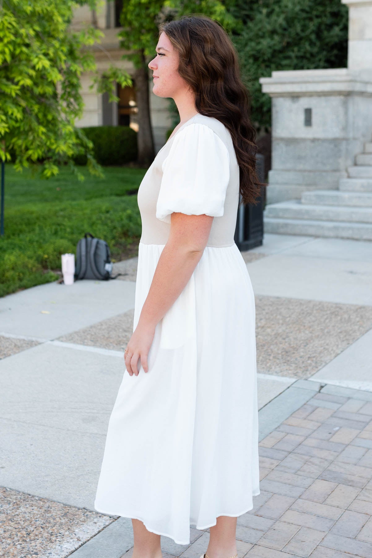 Side view of the plus size ivory knit bodice dress