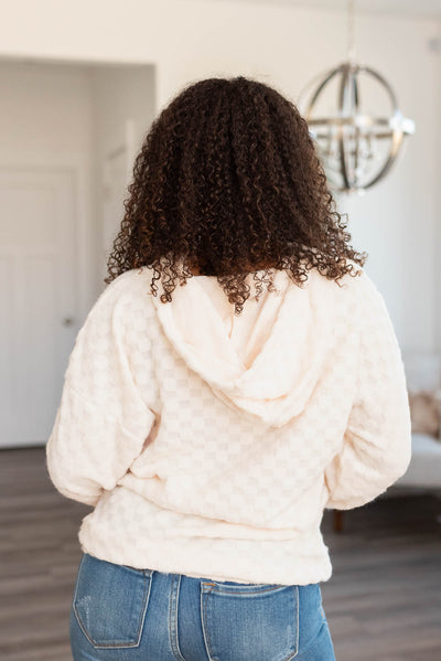 Back view of the fuzzy checkered sweater with a hood