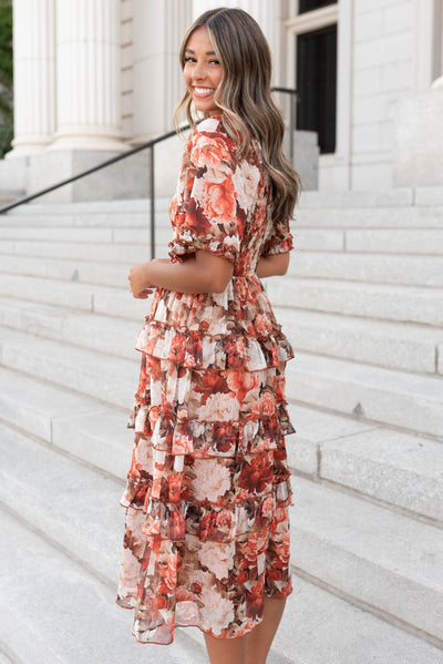 Side view of the rust floral uffle dress