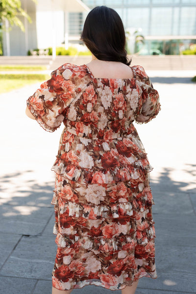 Back view of the plus size rust floral ruffle dress