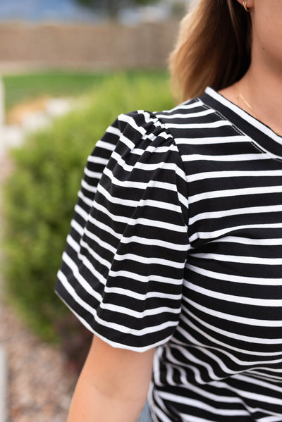 Close up of the sleeve and fabric on the blackstripe puff sleeve top