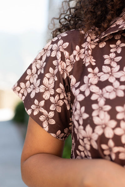 Close up of the fabric and sleeve on the brown floral dress