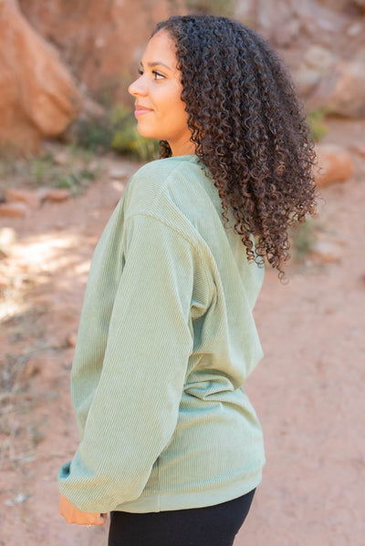 Side view of the green ribbed sweatershirt