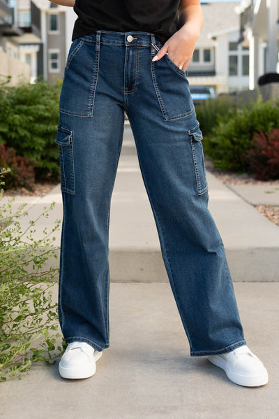 Dark wash cargo jeans with side pockets and front pockets