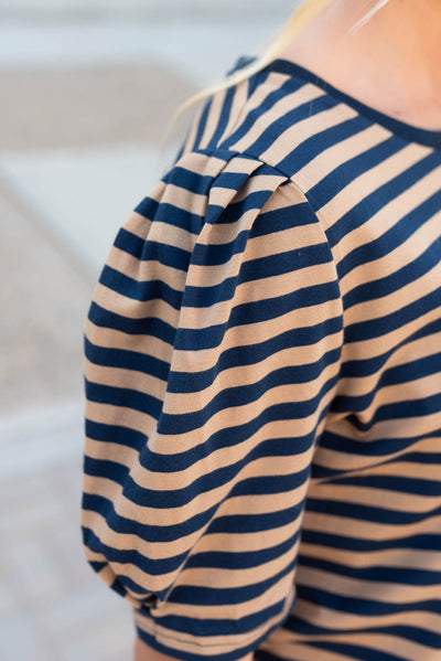 Close up of the sleeve on the navy camel stirpe top