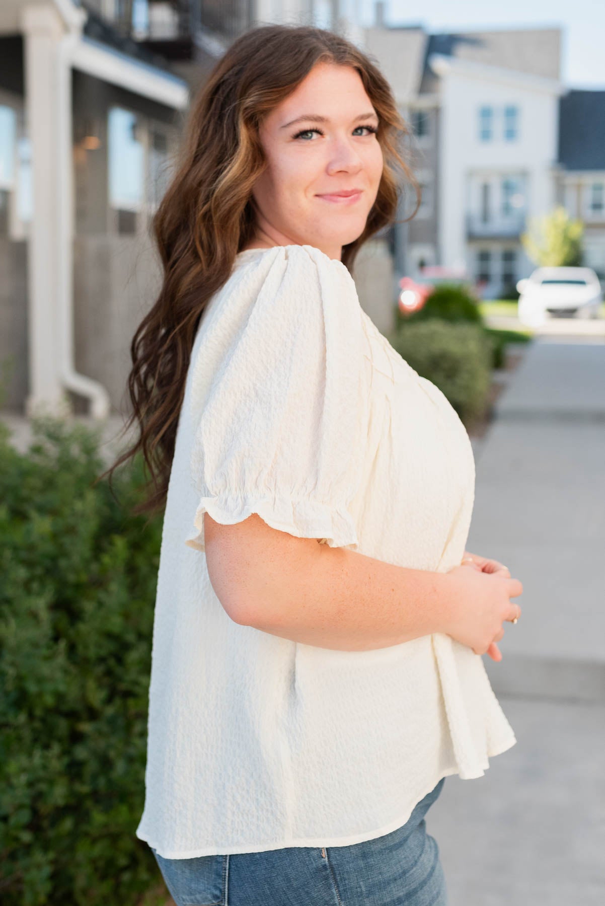 Side view of the plus size ivory blouse