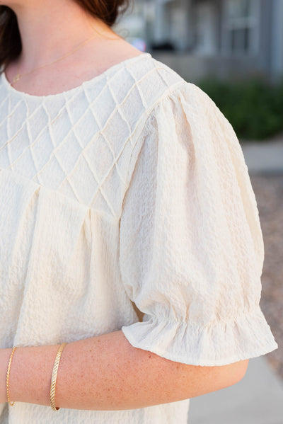 Close up of the sleeve on the ivory blouse