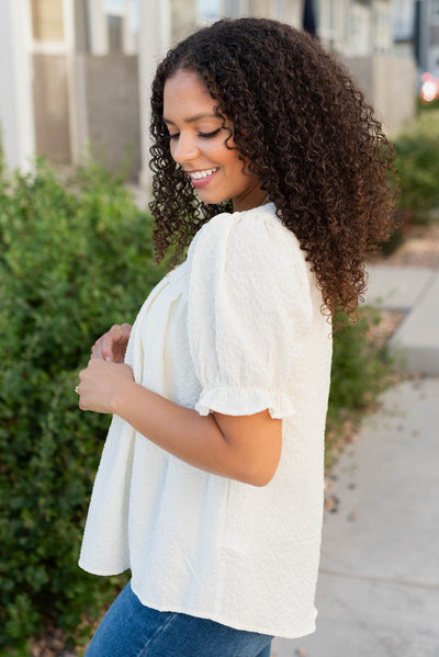 Side view of the ivory blouse