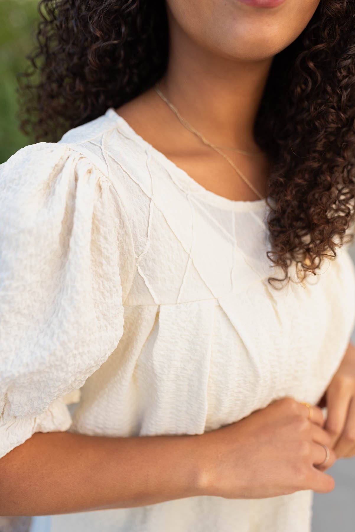 Ivory blouse with pleated line pattern