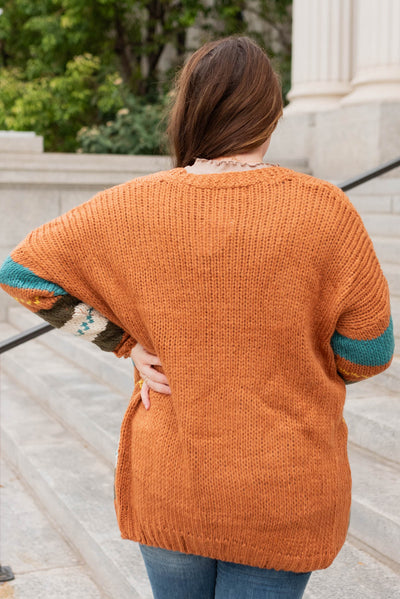 Back view of the plus size color block rust cardigan