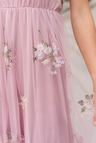 Close up of the fabric on the dusty pink embroidered dress