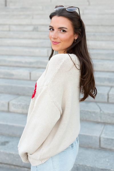 Side view of the oatmeal cherry sweater