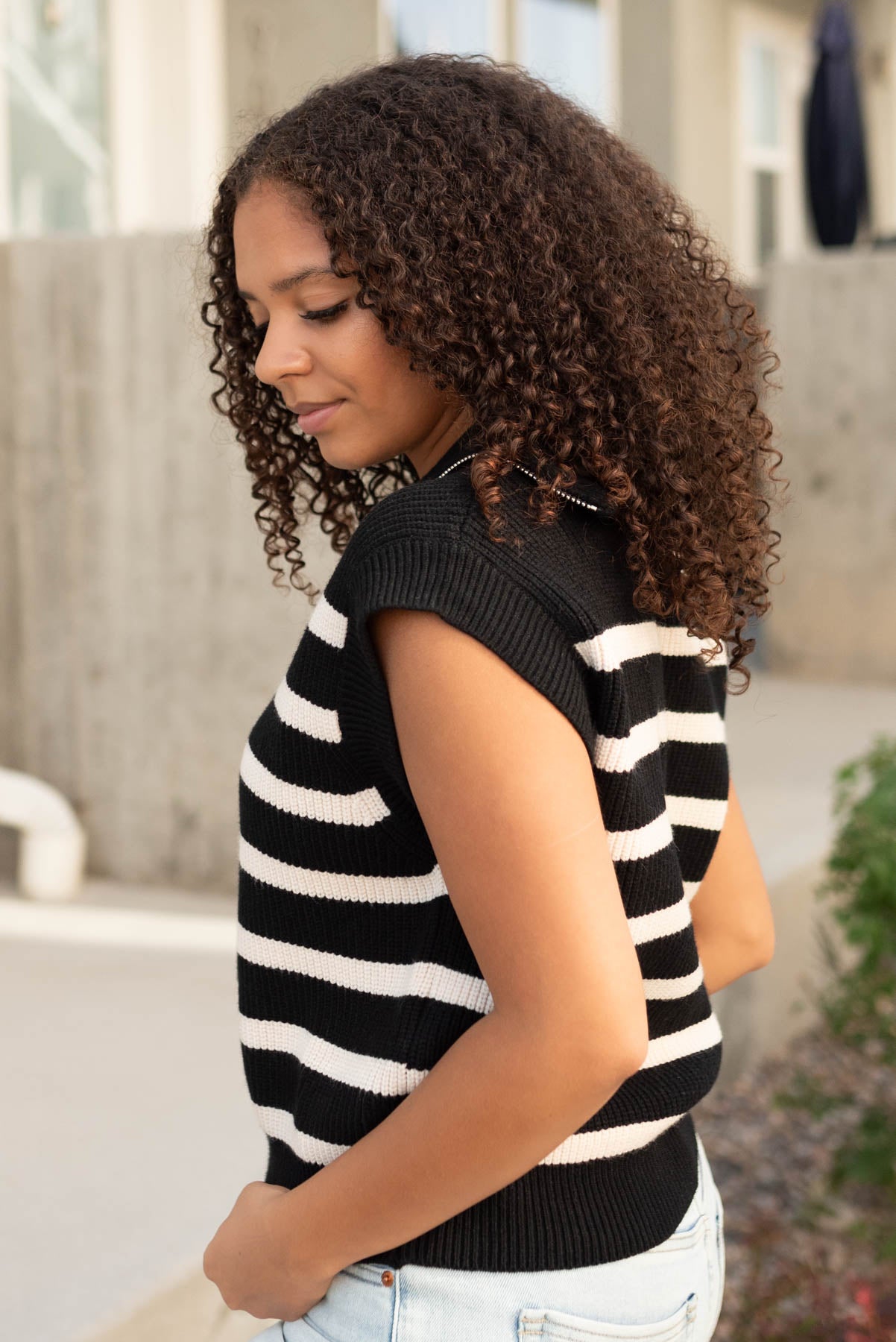 Side view of the black taupe stripe sweater