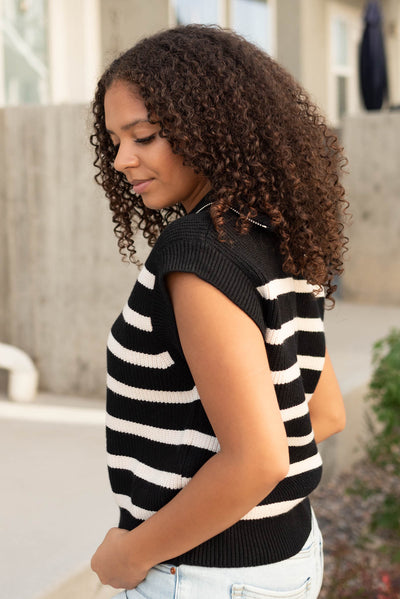 Side view of the black taupe stripe sweater