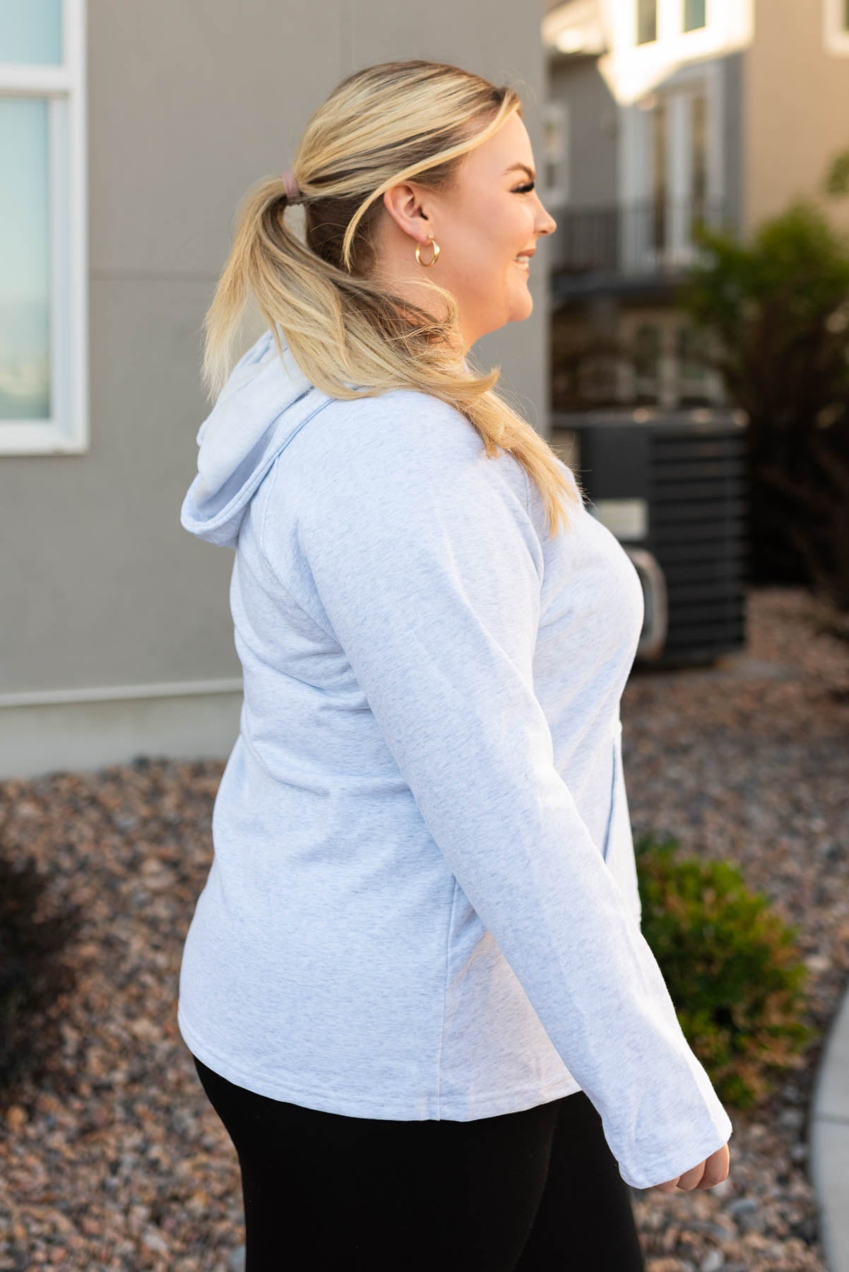 Side view of a grey button hoddie