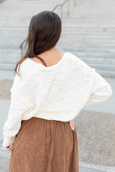 Back view of the oatmeal button up sweater