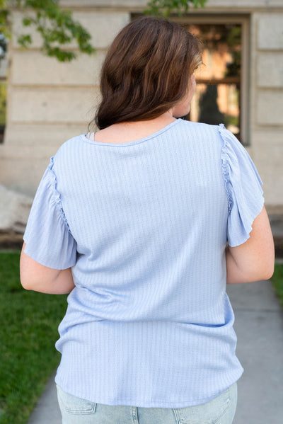 Back view of the plus size light blue textured top