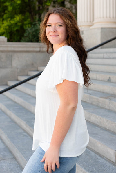 Side view of the plus size off white textured top